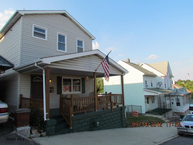Must see!!!! Enjoy your morning cup of coffee with a fabulous view of the city. This home boasts newer red oak floors, ceramic tile and oak kitchen with tile backsplash. The private backporch is enclosed and heated .... perfect for a small exercise room! The rear deck allows you to watch your pets and children play in the double lot. Parking is no problem with an oversized 2-car carport and off-street parking. Less than a block to a new playground. Priced to sell. Realtor Owned.