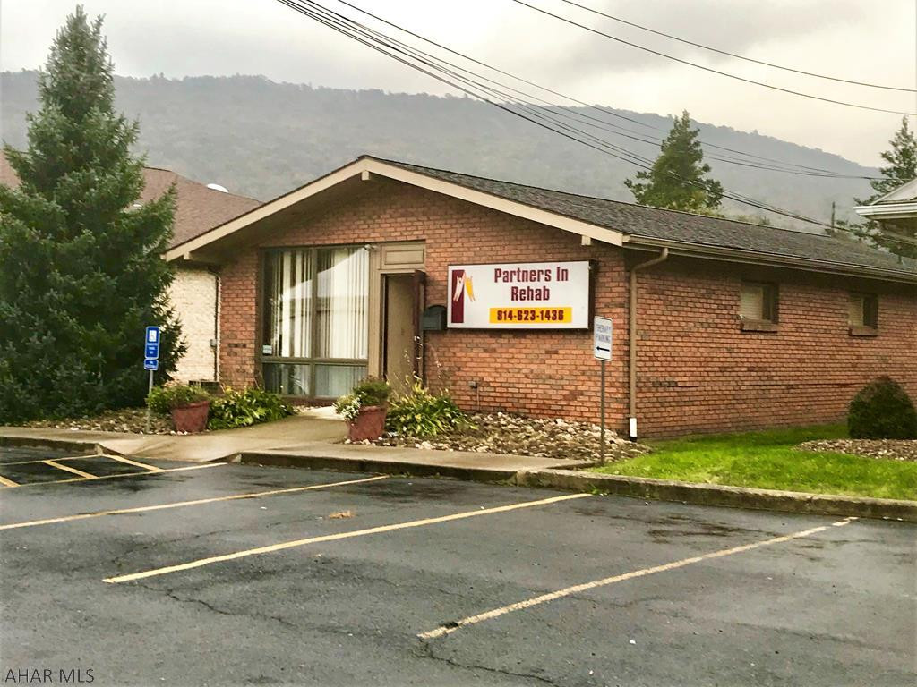 One-story brick office building containing 1,242 square feet with good visibility and exposure.  Building is in good condition and has a front macadam parking lot with spaces for five vehicles.  Interior has a reception area, three individual offices, mechanical room, half-bath, and the center section is open with a cathedral ceiling.  Heat pump with central air, 200-amp electric, updated electric water heater and security system. No basement, rests on a concrete slab.