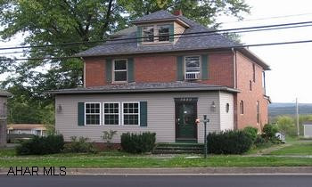 Historic 2.5 story brick home, 4BR/2BA, lavish sun room, original oak trim, elegant foyer, pocket doors, hardwood floors and original built-in cupboards in dining room and kitchen. Finished 3rd floor bedroom. Huge walk-out basement with workshop. 2nd floor balcony with view.