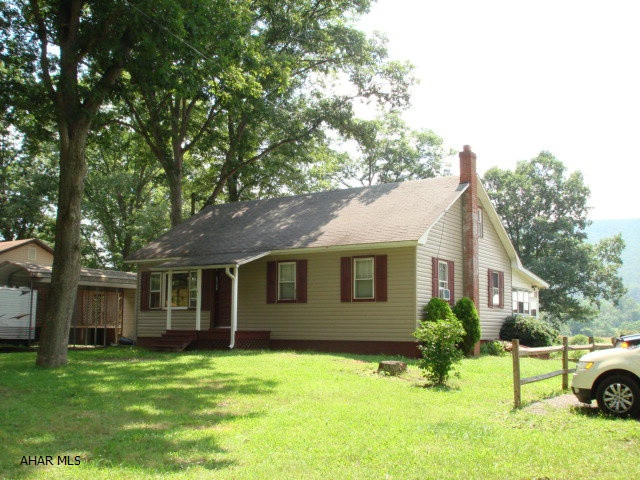 This is a cute one story home with a finishable attic, remodeled kitchen & bathroom on just over 1/2 acre. A recently added out building currently used as a photography studio, could be converted to a very nice garage. A pole structure on the porperty offers many possibilities. The living room, dining room & kitchen are open & spacious. The enclosed back porch could be enjoyed a good portion of the year. The large yard offers lots of outside enjoyment. Great possiblility for a business or car enthusiast.