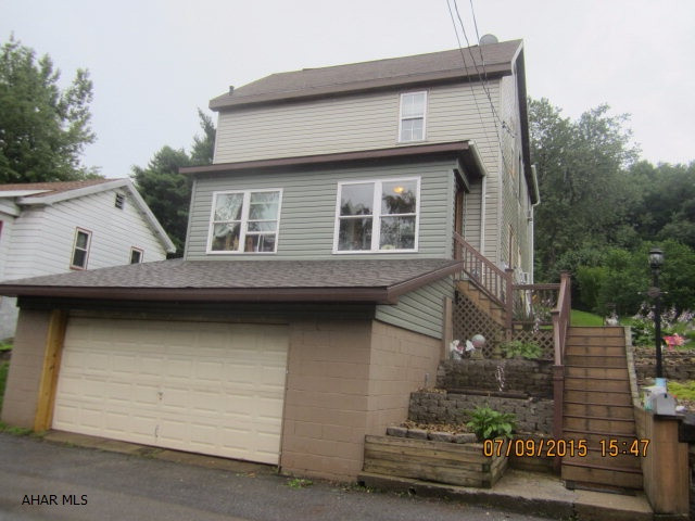 Don't miss this updated 3 bedroom 1.5 bath home with many added features!  Two heat sources-oil and wood/coal. 2 car garage and  lots of parking!!! The lot across the street provides plenty of additional parking. Relax after a long day in the Sauna! Check out the photos.