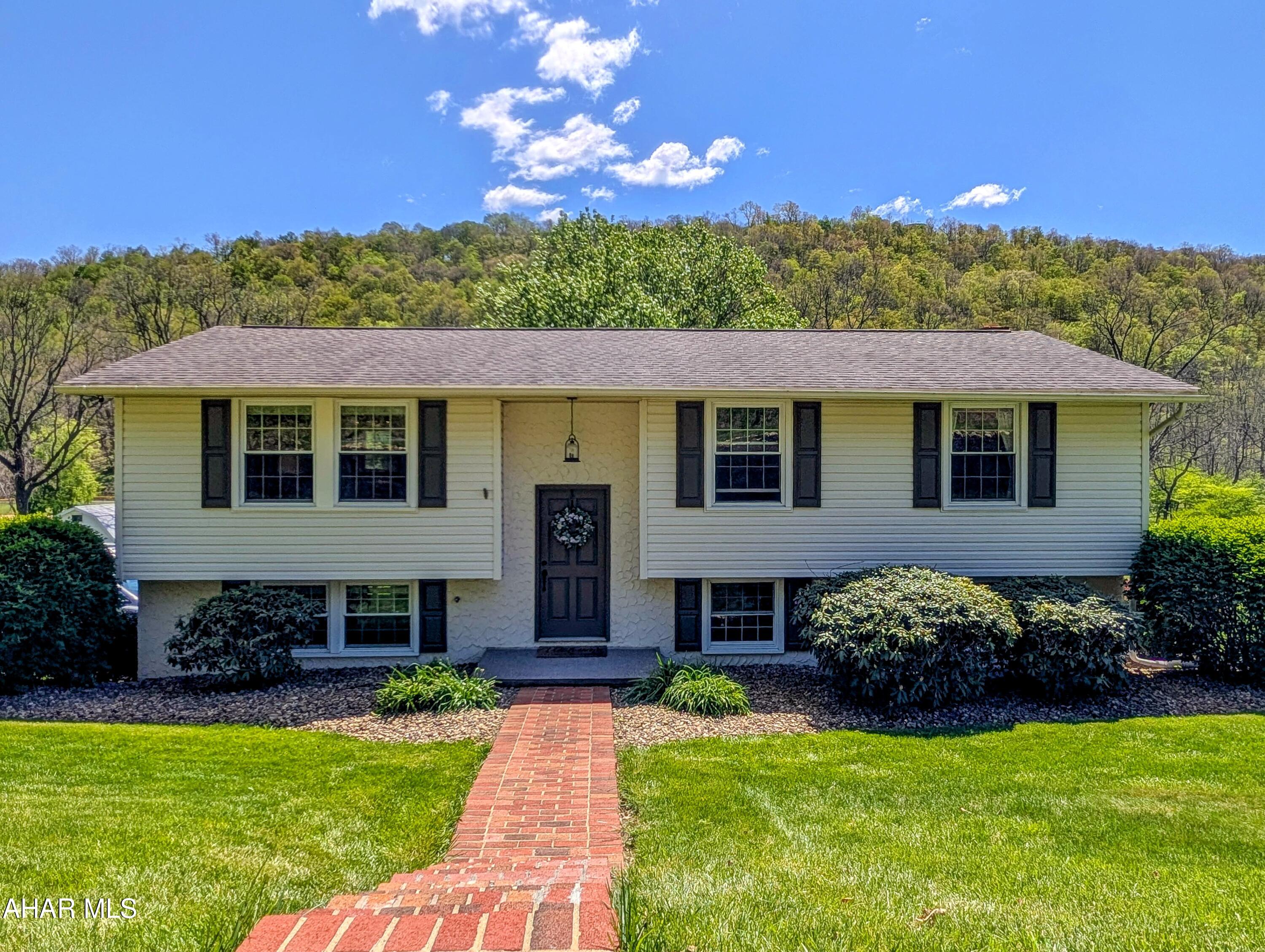 This impeccably maintained 3 bedroom, 1 bath home sits on just shy of an acre in the Bedford School District and offers a great mix of space, comfort, and location.  Inside, you will find a bright, open kitchen, dining, and living area with a large island that works well for everyday living or gathering with friends and family. All appliances are included, making this home truly move in ready.  The fully finished walkout basement adds additional living space and includes a wood stove for the colder months.  Easily customized this space could be made to fit any family's needs.  Out back, a spacious 24 × 16 deck overlooks the yard, complete with a kids play set, a small stream, and views of nearby ball fields.  Located just minutes from historic Bedford, PA, this home offers a convenient setting with a bit of space to enjoy. A great opportunity to own a home that is ready to enjoy from day one.