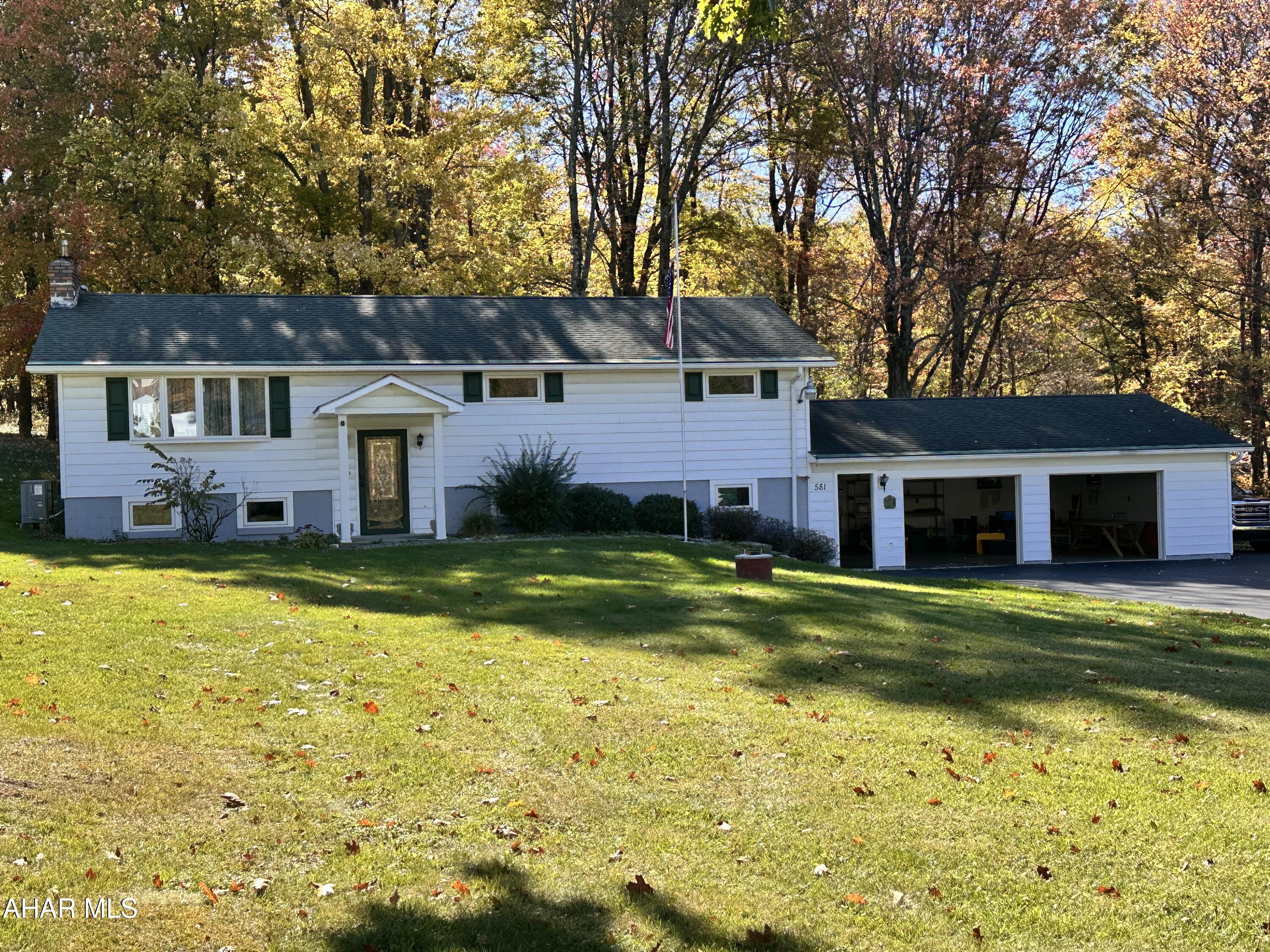 Beautiful split entry home with 2 car garage in a great setting! Recently remodeled kitchen with stainless appliances, first floor updated flooring,  modern bath and below grade 3/4 bath , family room with coal stove and workshop area. Heat sources include an heat pump, and coal and oil furnace. Enjoy nature from the patio or enclosed porch in the rear.