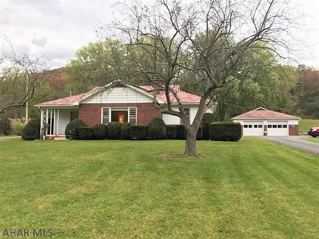 This is a well maintained and well constructed ranch home!! It features a large living room w/ picture window and stone fireplace w/ wood burner insert, dining room with built-in corner cabinet, kitchen, 3-bedrooms (including master w/ bath) & two baths.  Full basement that is finished w/ a big rec room, family room w/ fireplace & laundry room w/ walk-up to exterior. Updated oil hot water boiler, updated 200-amp electric, well & public sewer. Spacious 1.15 acre yard, over sized 2-car detached garage & black top driveway. Front covered porch, 14' x 48' rear covered flag stone patio & outdoor brick stove. Conveniently located to State Game Lands, H&BT Rails to Trails and a short drive to Raystown Lake!