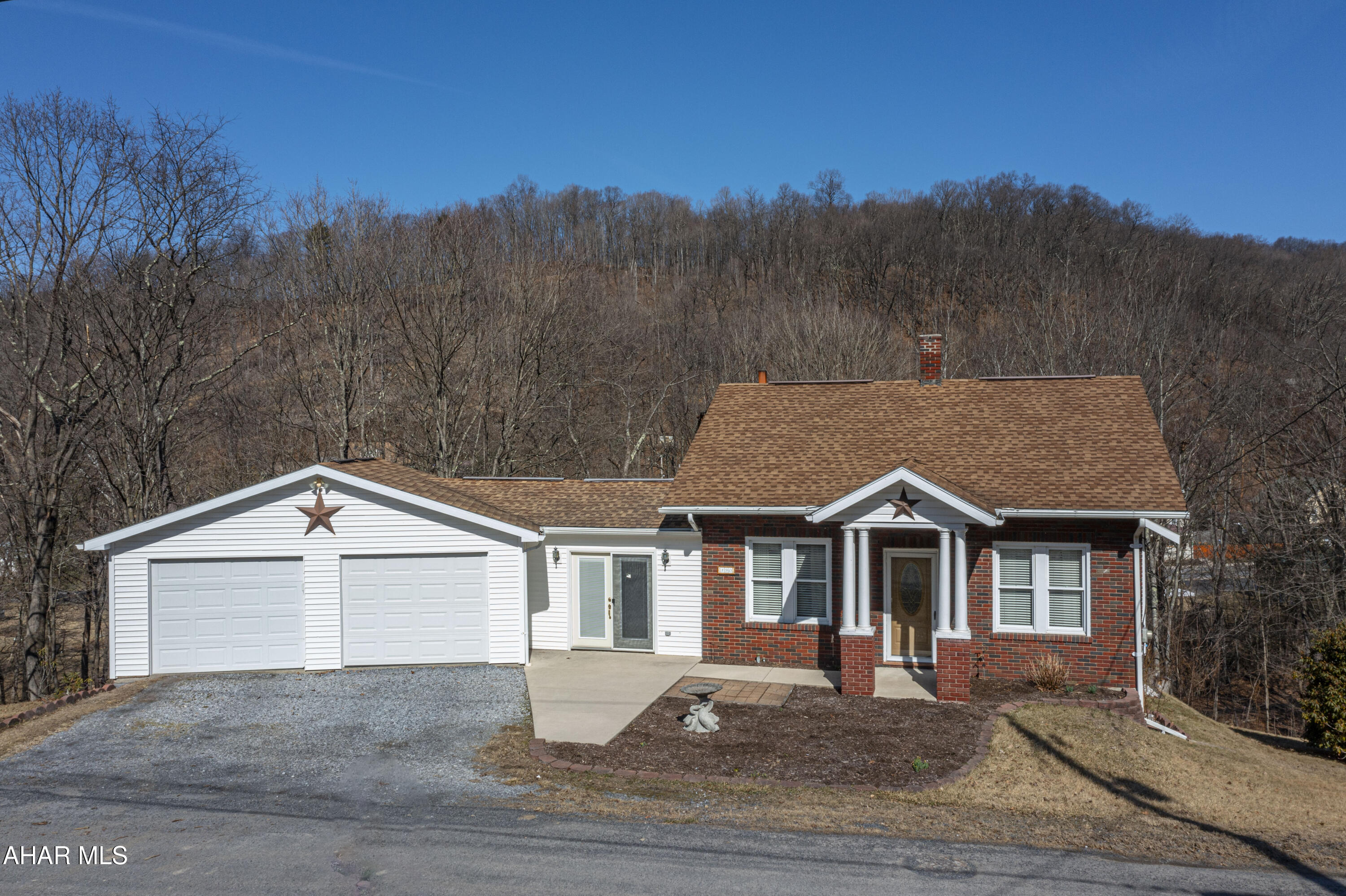 Check out this charming one-and-a-half-story brick home in Six Mile Run, packed with great features! The spacious eat-in kitchen boasts stunning wood cabinets, sleek black granite countertops, and tile flooring. Step right out onto the wraparound composite deck from the kitchen, perfect for outdoor relaxation. The first floor includes a cozy primary bedroom and a full bath. Upstairs, you'll find two additional bedrooms. A breezeway connects the house to a large two-car garage and includes a pellet stove for extra warmth. The home is equipped with oil forced air heat and an additional wood/coal burner for comfort.