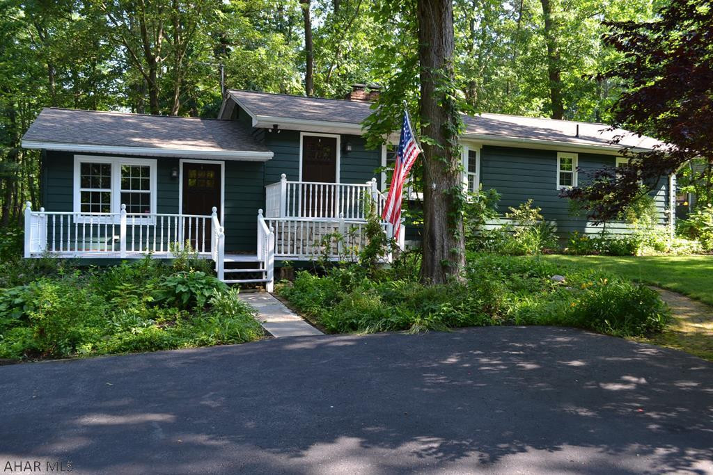 Beautiful ranch: 3 bedroom, 2 bath house in Lower Brush Mountain. Private secluded yard with almost 3/4 acre. Sit back on the porches and relax to the sound of nature right in the middle of Hollidaysburg! Updated with beautiful on suite master with its own entrance to the back covered patio. Charm and beauty await you in the large sunk in family room with stone fireplace.  Enjoy the view of the large front yard through the window of the living room with a second brick fireplace. Don't wait, this one won't last! You don't find this kind of privacy in Hollidaysburg often.