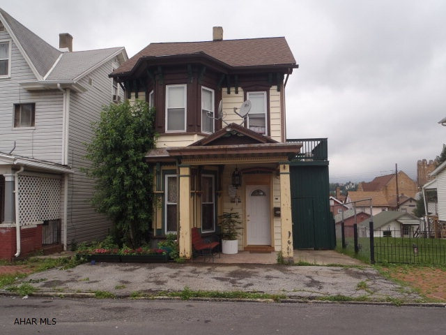 Spacious rooms.  Large remodeled eat-in kitchen with pantry.  First floor 3/4 bath.  Formal dining room.  Master bedroom has balcony.  Third floor is carpeted, but not heated.  Covered front porch, fenced back yard, offstreet parking.  Updated wiring, newer windows.