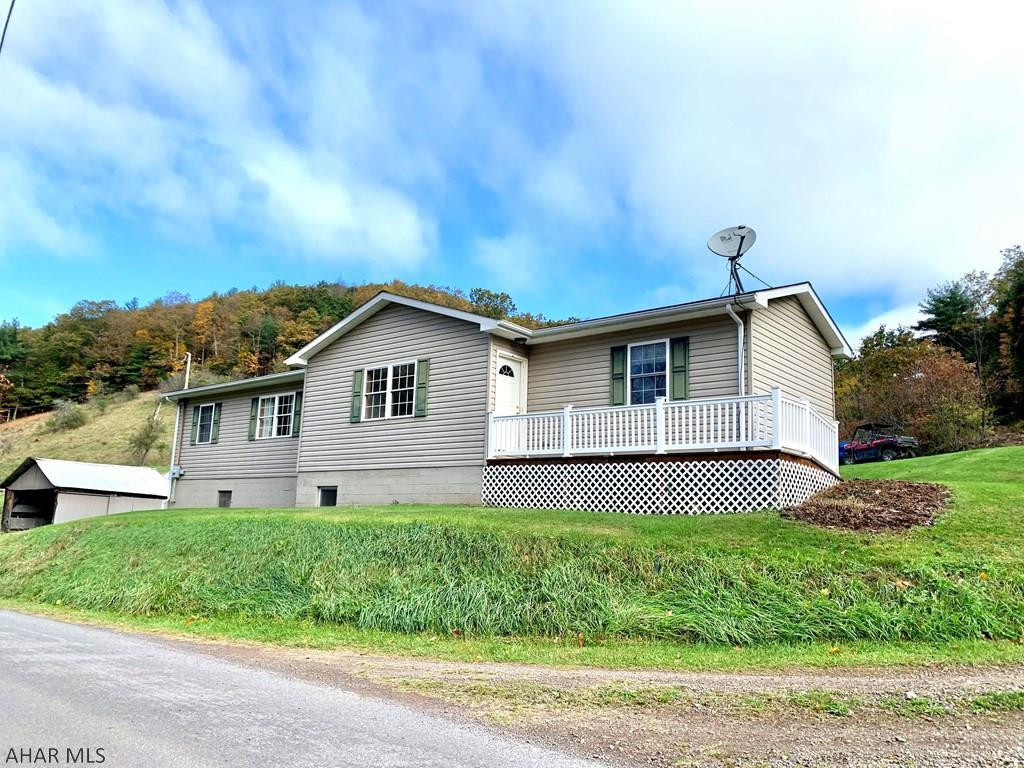 Enjoy the peace and quiet at this cozy home located in Buffalo Mills, Bedford County.  This 2 bedroom, 1 bath home is cozy on the inside and offers an open concept living area between the kitchen, living room and dining room areas for all to gather and entertain. Outside enjoy the 5.13 acres that has some cleared space and some wooded with a small stream on the property and views of the mountainsides.  The fall foliage colors will not disappoint this time of year. If you enjoy the outdoors there is plenty of space for all of your outdoor toys, machinery and storage with multiple outbuildings located on the property.  Property is on both sides of Clites Road which is a township road.  This property has so much to offer so don't wait to schedule your tour today!
