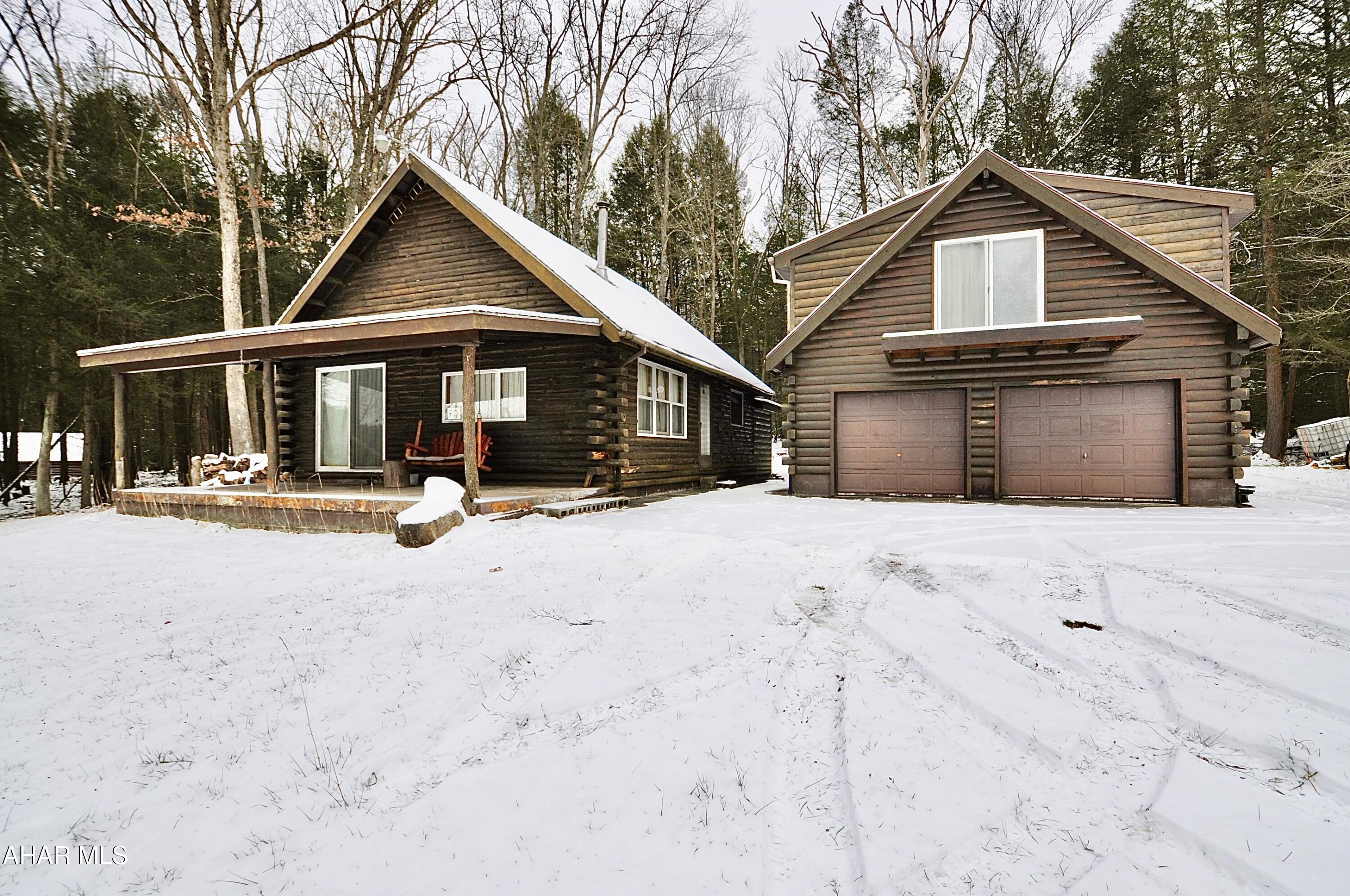 Hidden away at the end of a long, private lane, this wonderful 194.553 acre retreat provides privacy, seclusion, and lots of room to roam! The main cottage contains 2 bedrooms, 2 bathrooms, living room, kitchen and loft. The detached 2 car garage has a finished 1 bedroom guest suite upstairs, with full kitchen, living room and full bath. Located on the Bradford and Graham Township line, just east of Clearfield Borough in Clearfield County, PA. 15 minutes to Route 322 and 20 minutes to Route I80. On site septic, water, public electric to the garage and cottage. All mineral, oil, timber and gas rights convey. A wonderful place to live full time or whenever you want to get away and recharge. Acreage calculated by Curry and Associates Surveying, Clearfield, PA.