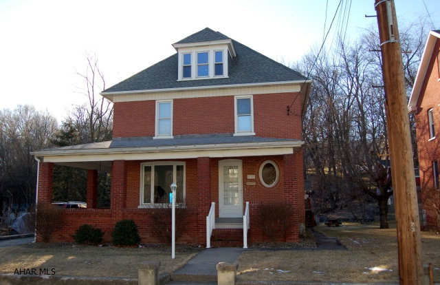 Large brick home situated on two lots. House is situated on larger lot 50 x 153 (0.1756 a) 18-3-116 and second lot offers privacy behind the house 56 x 90 (0.1157 a irreg) 18-3-207-1 Has detached garage, nice back yard with extra wooded lot behind the house which gives privacy.  Nice deck with retractable awning; very nice woodworking, large rooms, pocket door, lots of storage.  Home needs some updating inside; but outside brick was just re-pointed and large wrap-around front and side porch with composite floor. Pool table in the attic can stay or go; freezer in basement can stay or go. Hardwood floors under most of the carpet--no hardwood floor under kitchen flooring.