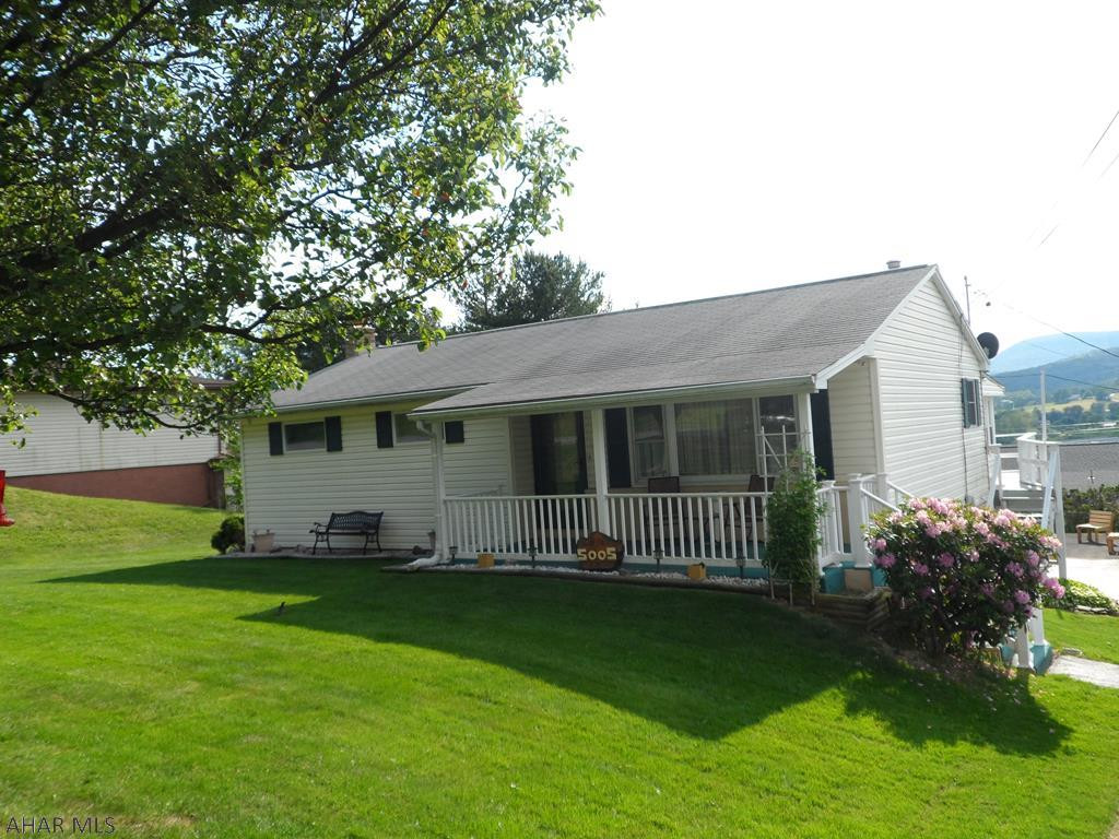 This ranch offers a country setting and is situated on over 1/4 acre manicured lot.  New kitchen and baths, hardwood floors, 2 yr old furnace and central air, finished basement offers large family room with wood stove, first floor sun room makes entertaining a plus of just a great area to relax.  Has 2 integral garages and a 2 car detached garage.  Taxes are low for what home has to offer.