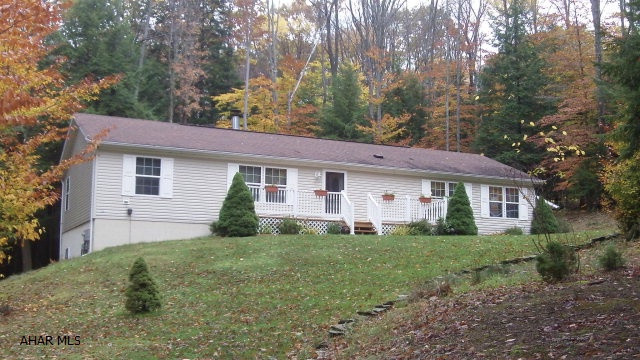 Well-maintained, beautiful double wide with LOTS of extras.  Mostly furnished home ready for you to move right in.  Kitchen includes appliances, corner hutch, dishes/silverware/bakeware; Master Bedroom has king size bed, chest of drawers, chairs and table.  Extra bedroom has built-in desk/chair, daybed, bookcase.  Living room: sofa, 2 recliners,tables, lamps, clock.  Basement includes pool table, treadmill, free-standing ventless fireplace, 32 flat screen tv, built-in bar, extra refrigerator and chest freezer.  2 car garage houses your Poulan Lawn tractor/cart/leaf sweeper, chain saw, gas weed eater and yard/lawn tools.  All of this in addition to the amenities of Glendale Yearound / Prince Gallitzin State Park.  Community pool, tennis/basketball/volleyball courts, Glendale Lake, Gated