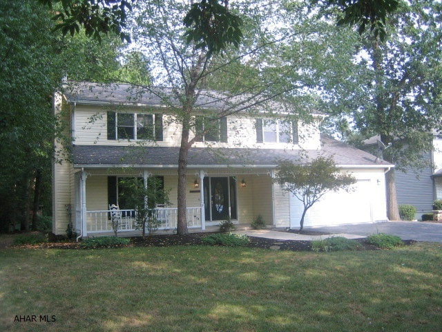 FANTASTIC HOLLIDAYSBURG HOME with large, wooded lot. One year home warranty! New carpeting and freshly painted throughout. Beautifully remodeled eat-in kitchen with center island, dining area and adjoining great room. Living room with gas FP, formal dining room, master bedroom suite with walk-in closet, and finished basement with family room and posh office. Relaxing front porch, large rear deck, 2 car attached garage with openers. 4th bedroom adjoins master suite.