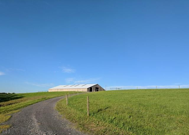 Are you looking for multiple barns and pastures on 105 acres, with possibly a 3 bed, 2 bath house thrown in? High quality fencing, fantastic views, a pond and streams, multiple machine/run-in sheds can all be found on this one property! What about hunting? Here it is! Deer, turkeys, rabbits, bear, squirrels even wood grouse call this property home. Rural life at it's finest with projects to really make the place feel like your own. So we have the newly built huge pole building with heated concrete floor system in place, and we also have a home with serious character and charm from the 1800's. The house will take some finishing, but while deciding exactly how to display the beautiful hand hewn logs in the huge living room which opens to your covered deck, relax and enjoy the view!
