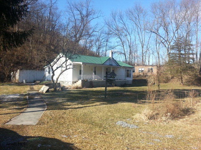 Ranch home with frontage on Clover Creek for excellent trout fishing. Building behind house is used for storage.