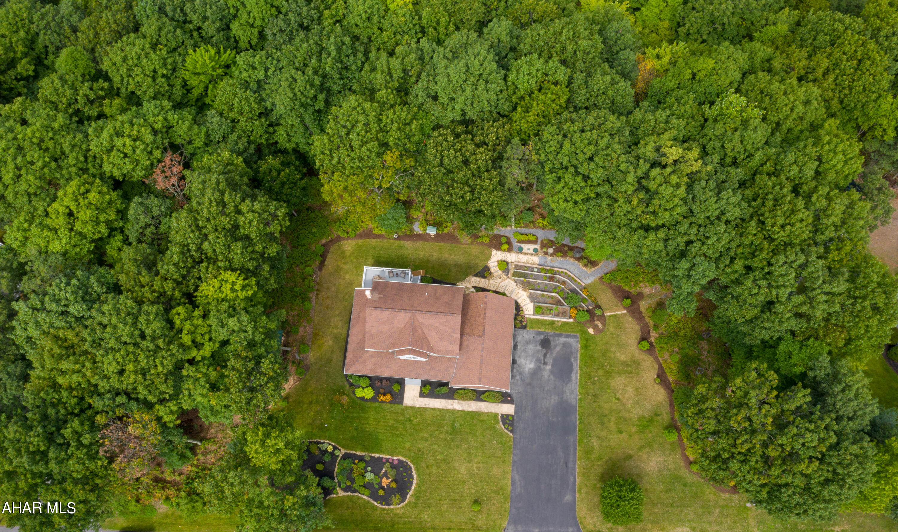 Impeccable 2 story home situated perfectly on almost 2 acres in Laurel Heights just minutes away from I-99. Featuring 3 bedrooms and 2.5 baths, this gem will be sure to check off all of your boxes! Upon entering the front door you will find original hardwood flooring that is meticulously kept throughout the first floor. Beautiful French doors separate the dining room and kitchen.  The kitchen is open to the living room and offers stainless steel appliances, quartz counter tops, tile backsplash and plenty of natural sunlight with sliding glass doors that open to the back deck.  First floor laundry room, a half bathroom, and a spacious mud room with a large closet completes the first floor and makes a great space for extra storage or even workout equipment! The master suite offers a walk in closet, and master bathroom with a double vanity.   The partially finished lower level makes a great space for entertaining or recreation room. Easily add a lower level full bathroom with rough in plumbing already done, the possibilities are endless! Spend evenings relaxing on the wrap around porch or on the patio outback!