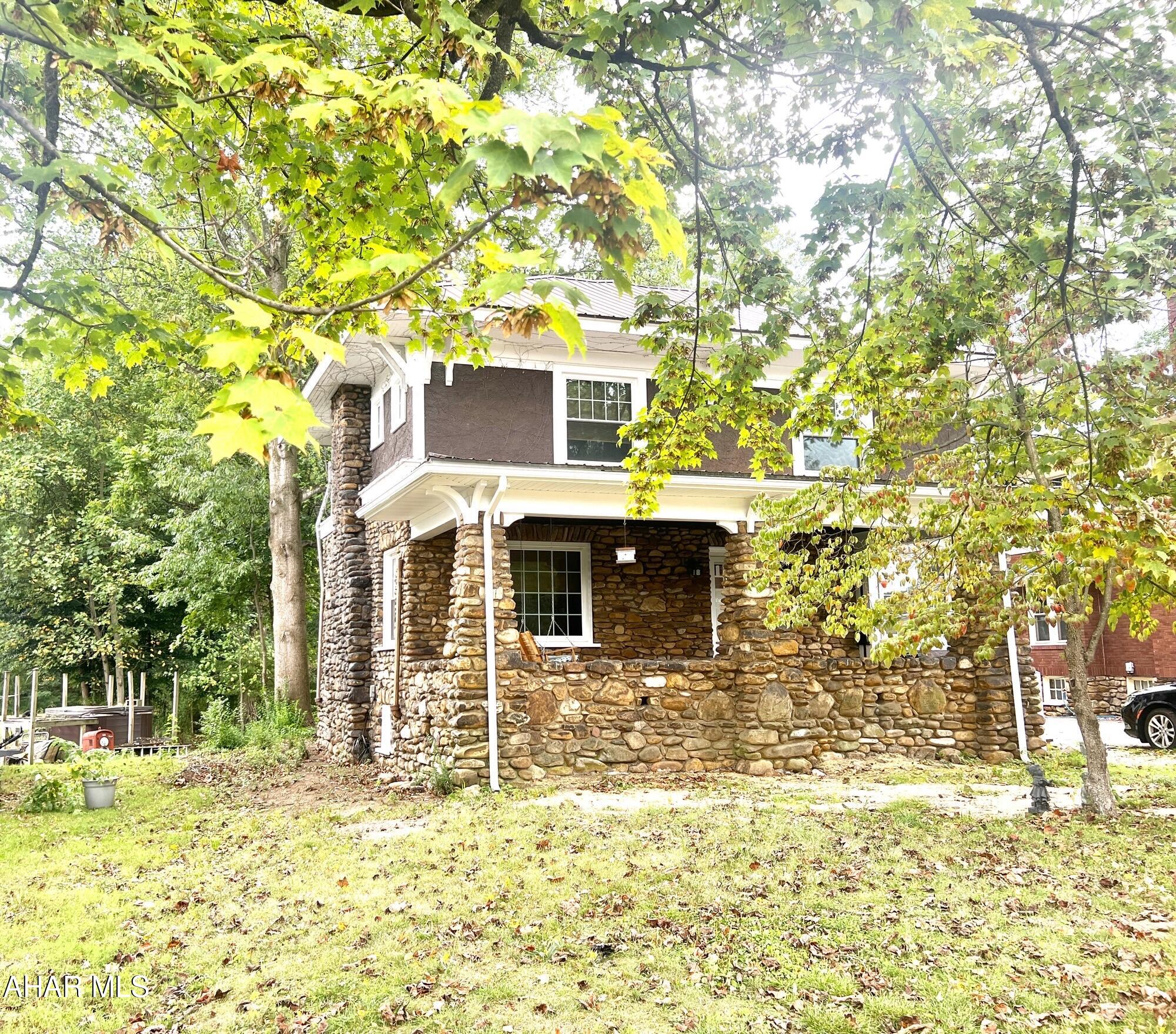 Timeless 1925 Stone Home with Modern Comfort & Historic Charm...
Welcome to this unique 1925 home, built with river stone gathered right from the property - a detail also seen in the one car garage and the large stone fireplace. Lovingly owned by the same
family for 55 years, the home has been well cared for and thoughtfully updated for today's lifestyle. Enjoy year-round comfort — naturally cool in the summer and warm in the winter — thanks to
the solid stone construction and fireplace with a cozy pellet stove insert .
The spacious front porch invites you to relax with a morning coffee or entertain family and friends in a peaceful setting.
Inside, you'll find all-new flooring and paint throughout, a recently installed metal roof, and updated windows (within the past 5 years). Upstairs, the main bathroom features a stylish walk-in shower, with a separate water closet next door for added privacy and convenience.
Spacious third-floor master suite featuring a charming bay window, cozy sitting area, and plenty of room for a California king bed. Includes a convenient half bath and a generous closet for ample storage. A perfect private retreat within the home.
A private 3-season room offers a peaceful spot to enjoy the yard and nearby creek. Large windows bring in plenty of natural light, making the home bright and inviting. The full basement and garage provide ample storage space and includes a dedicated workshop area, ideal for hobbies or projects. This property is move-in ready and perfectly located—close to schools, shopping, and local
amenities. Don't miss your chance to own this unique and lovingly maintained home. Call today to schedule your private showing.