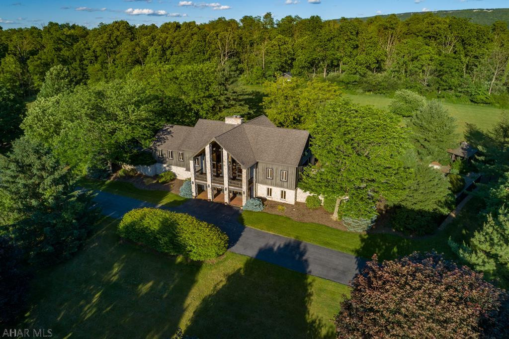 You will love this sensational, custom, "lodge-like" Post/Beam/Stone home on 11.46 acres.  The inviting & winding tree-lined entrance begins across from the Sinking Valley Country Club.  The brick & stone, outdoor living area is fantastic & includes an in-ground pool (3'-10'), a gazebo, a hot tub cabana, a waterfall pond, and an arbor.  The picturesque landscaping includes daffodils, forsythia, raspberry bushes, 1 McIntosh apple tree, 5 Red Delicious apple trees, a Maple tree, 2 big Locust trees, a Cherry tree, a Weeping tree, and the largest Colorado Blue Spruce that I have ever seen.  The inside features cathedral ceilings, a double-sided gas fp, granite counters, ss appliances, brick basement floors, and a stone bar.  It's stunning!  A nature-lover's dream.