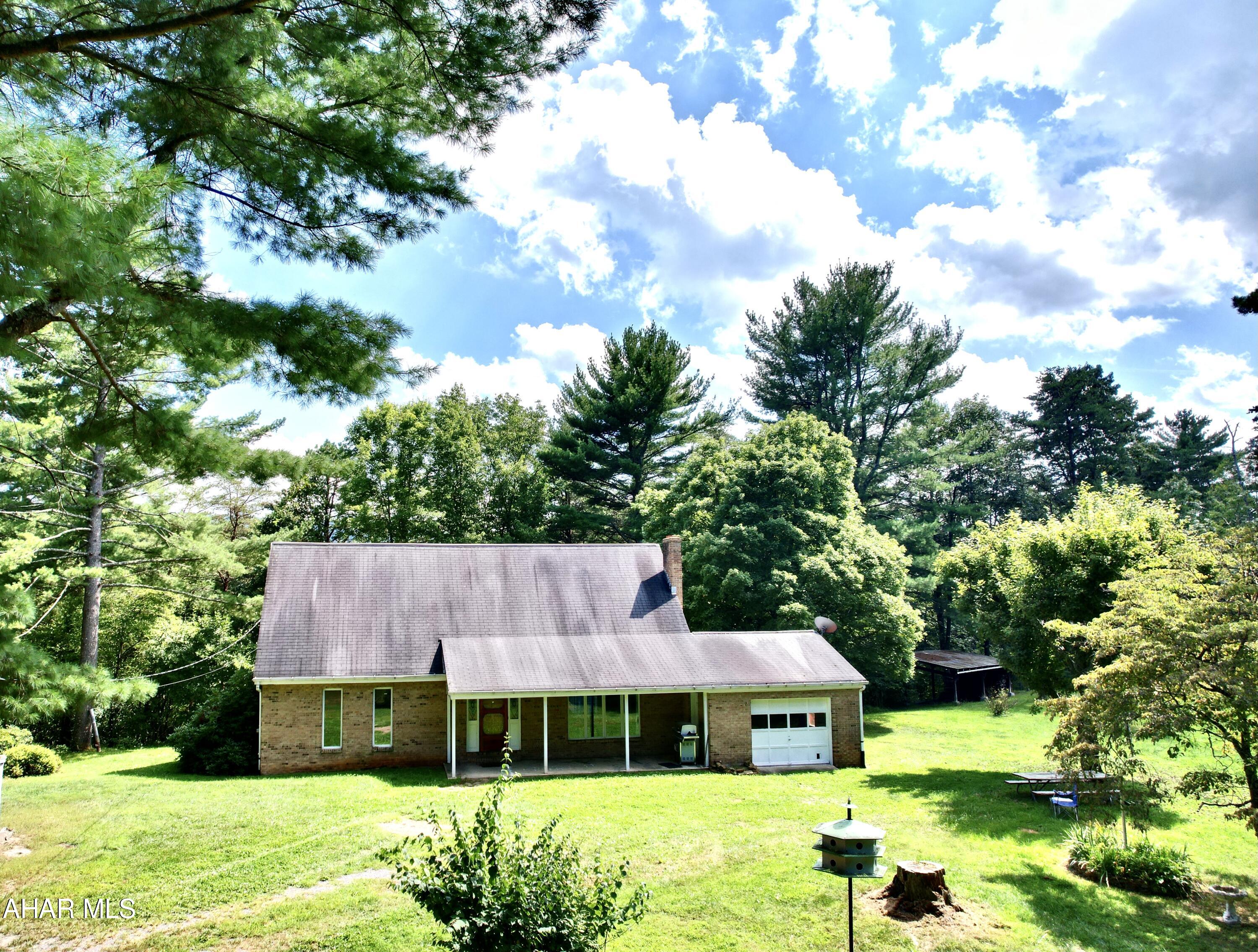 I caught you looking at this SWEET home nestled in the hills of Clearville, PA.  Hard to find stick-built brick home with approximate 7 acres.  Wonderful home with 4 spacious bedrooms, 2 full baths.  Plenty of living area including a large living room flowing into the dining room and kitchen. Beautiful hardwood floors throughout.  Enjoy the BEAUTIFUL views and garden.  Multiple outside storage/workshops.  A frame building was once used as weekend getaway. make it your own!!
