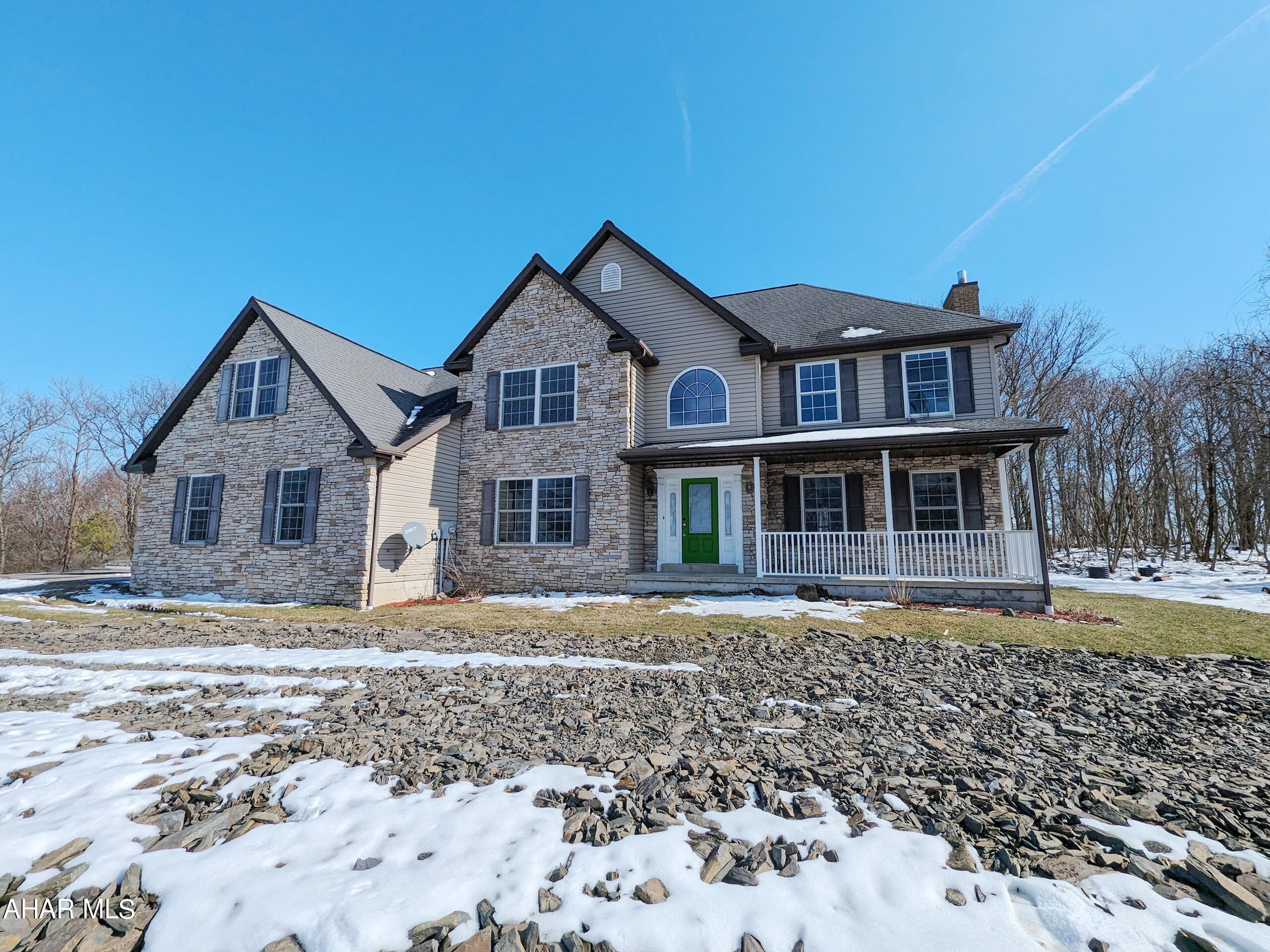 Large stone and vinyl 2 story Hollidaysburg area home on 16.49 private acres. First floor features formal living and dining rooms, large eat-in kitchen (cabinets missing) opens to spacious great room with vaulted ceiling and stone FP plus half bath and den. Second floor features 4 bedrooms including huge master suite with adjoining sitting area plus 2nd floor laundry. Large 3 car attached garage, rear patio. AS-IS sale. Seller will make no repairs. Buyer pays both transfer taxes. Photos are digitally enhanced.
