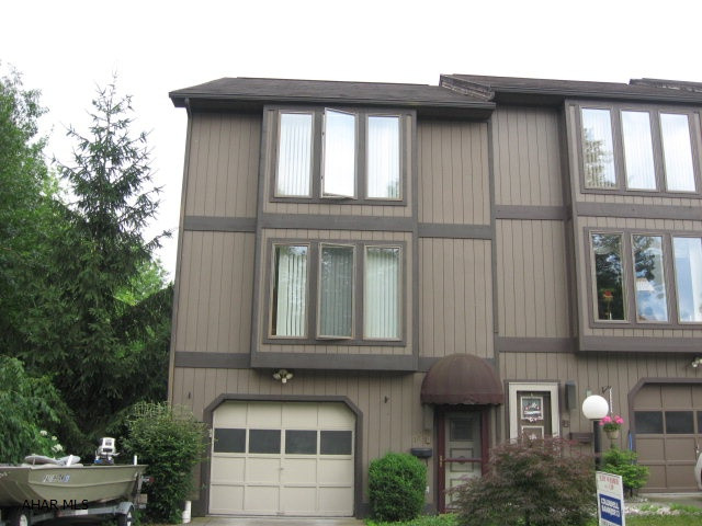 Corner townhome with double driveway and additional ground.  Spacious rooms. Covered patio plus deck.  Landscaping pavers surrounding a lovely pond.  No Association Fee.  Home Warranty Included.  Deed Restrictions.  Security System not activated.