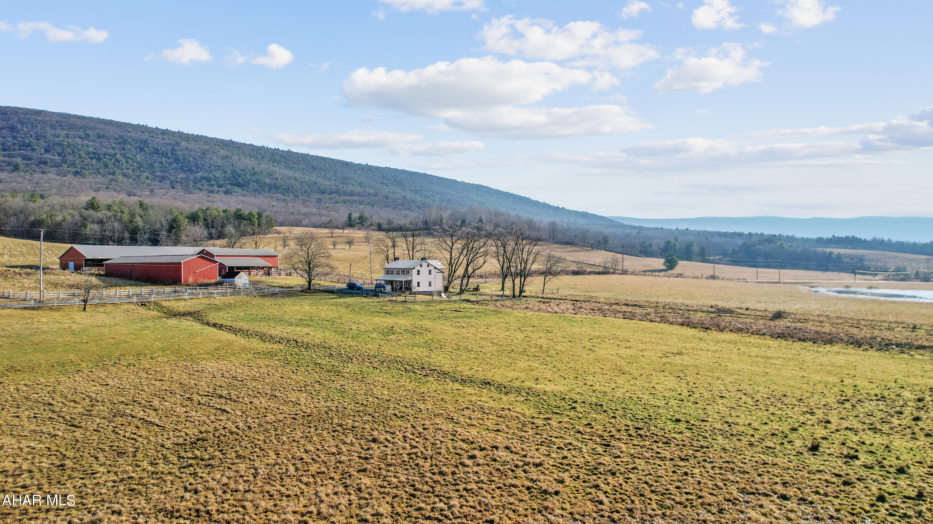 This farm is nestled in the historical Dutch Corner area of Bedford County. Resting on 119.81 acres, the entire site is encapsulated with fencing and currently used for beef and crop farming. The rolling acreage offers beautiful scenic views, large spring fed pond, stream, wooded areas for animal shade and shelter belts, pastures and tillable land. 75-stall feeder barn, updated bank barn with electric and water, machine and hay storage building, and a block milk house used for storage. This property is very adaptive to many agricultural uses. The home offers a living room, large dining room, kitchen with a view, 1.5 baths, second level laundry room and four bedrooms. Updates include a new kitchen, 1/2 bath on the main level, full bath, windows, zoned heat pumps with CA, wiring, water heater, and many other items.