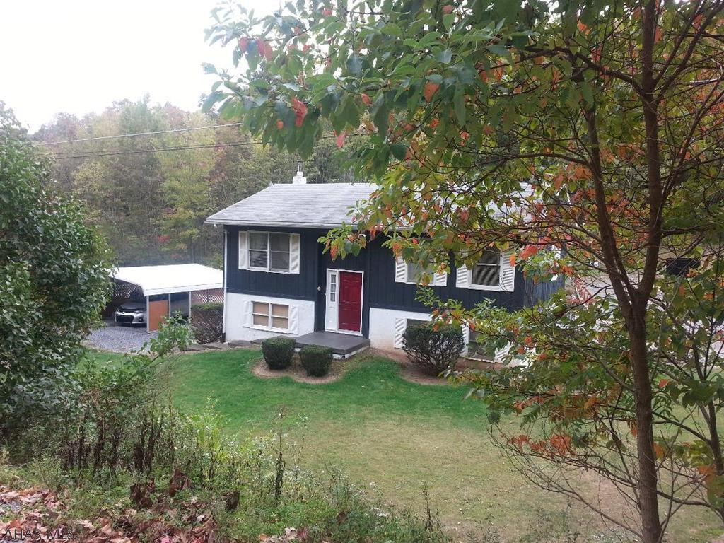 Bi-level home on 1 acre with additional 3 acres in rear.  Stream on property (not in floodzone). 2 car carport included. Total taxes for house + 4 acres are $1792.00.  Taxes, lot size & sq ft to be confirmed by buyer