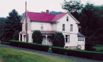 Victorian farmhouse, large rooms, wainscoting, and built-in cupboard in formal dining room. Also barn and stream.