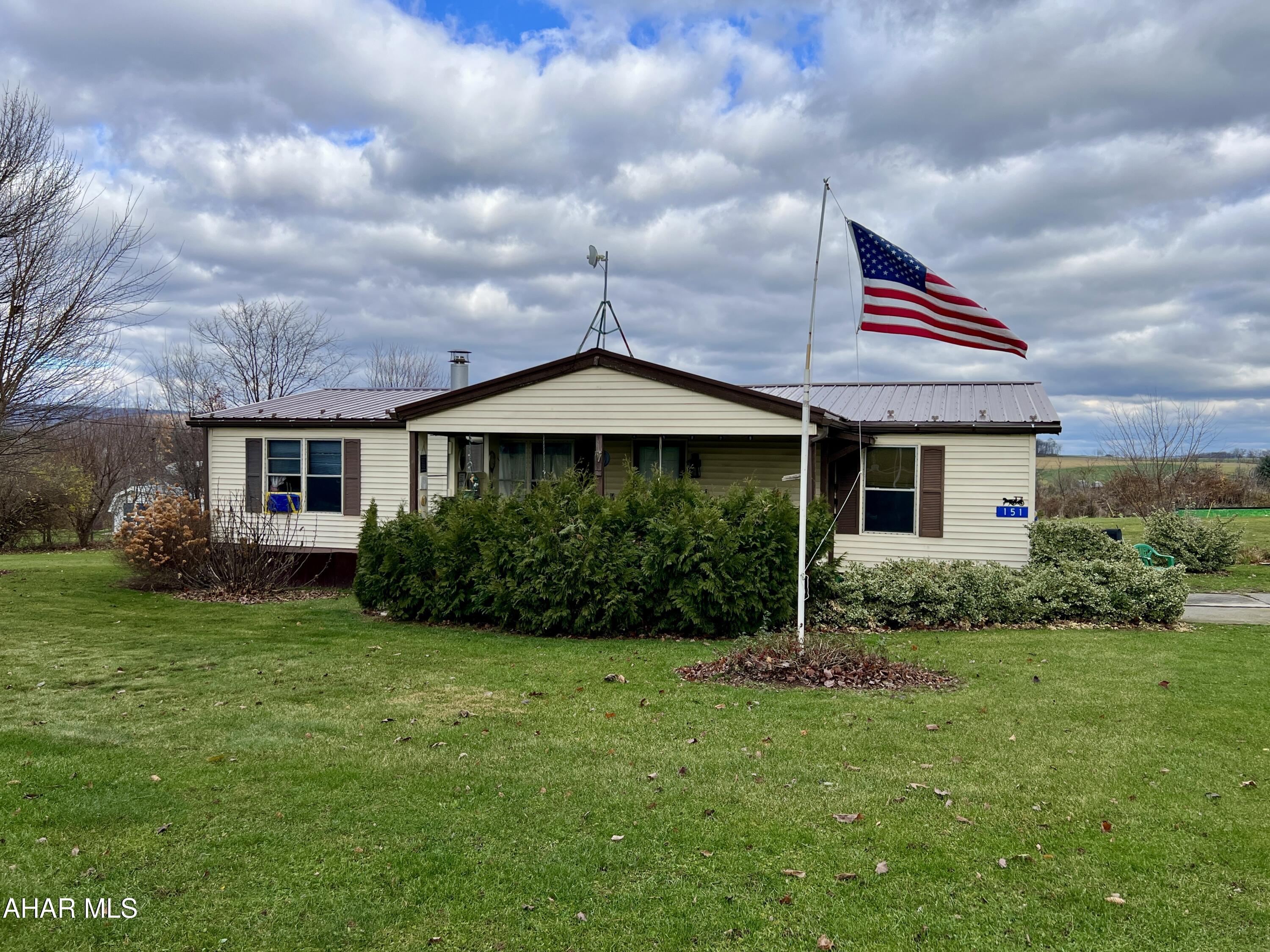 Manufactured home located outside of town offering great views of the countryside. The home features 3 bedrooms, 2 baths, living room with fire-place, eat-in kitchen, & laundry. Outside, you will find a covered porch, new metal roof (2024), detached 1 car garage, large yard, and raised garden beds.