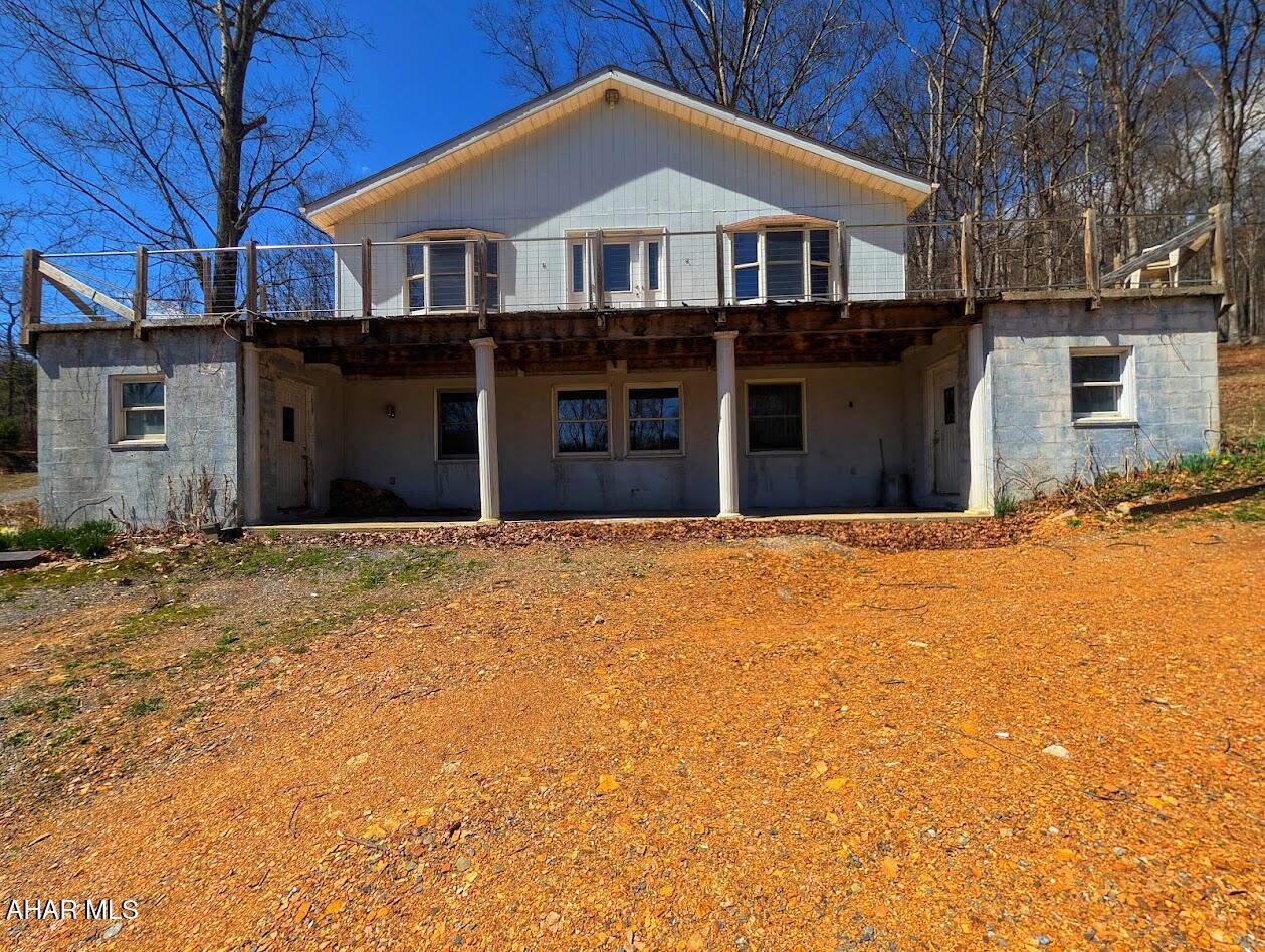 Escape to your own private mountain retreat with this custom-built home nestled on 20.95 acres of breathtaking Pennsylvania landscape. 

Offering total privacy, panoramic views, and direct access to Buchanan State Forest and the Mid State Trail, this property is a rare opportunity for those seeking space, seclusion, and connection to nature.

The upper level features a spacious great room with open-concept living, dining area, and kitchen, complemented by a large walk-in pantry, office space or den, and half bath. French doors lead to a wraparound porch perfectly positioned to take in sweeping mountain views.

The second level offers incredible flexibility, featuring a full secondary kitchen with adjoining laundry area--ideal for hosting extended family, multigenerational living, or flexible use. This level also includes three bedrooms, two full baths, and access to a front porch.

The inground basement level provides additional space for a workshop, home gym, or storage, complete with a wood-burning stove. An oil furnace and tanks are present but not currently connected.

Outside, the property truly shines with a three-car carport, charming two-story spring house, and a peaceful creek winding through the land. Enjoy nearby recreation with state game lands, excellent fishing just minutes away in Flintstone and Town Creek, and quick access to Rocky Gap Casino Resort and Golf,  and I-68.

While the home requires updates and finishing touches, the setting is simply unmatched. Whether you're searching for a private residence, retreat, investment opportunity, or legacy property, this land delivers the kind of beauty and potential that's increasingly hard to find.