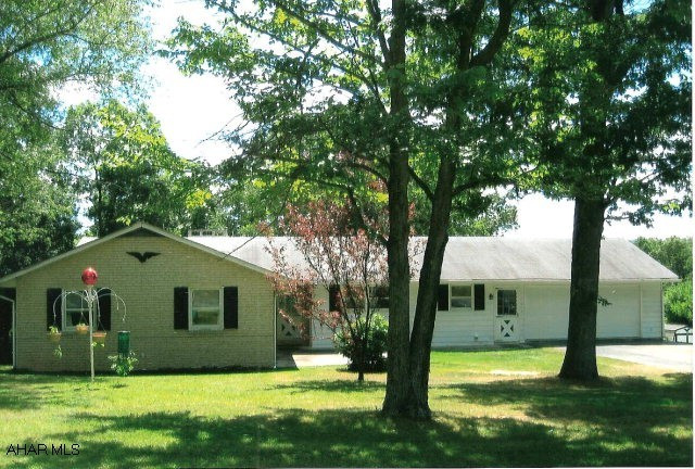 Home built in 1975, has very good bones. 4BR/, 4 garage spaces, central air, wood fireplace in basement area with lots of potential. Property is 11.6 acres, has paved drive, small shed and pond. Great location.
