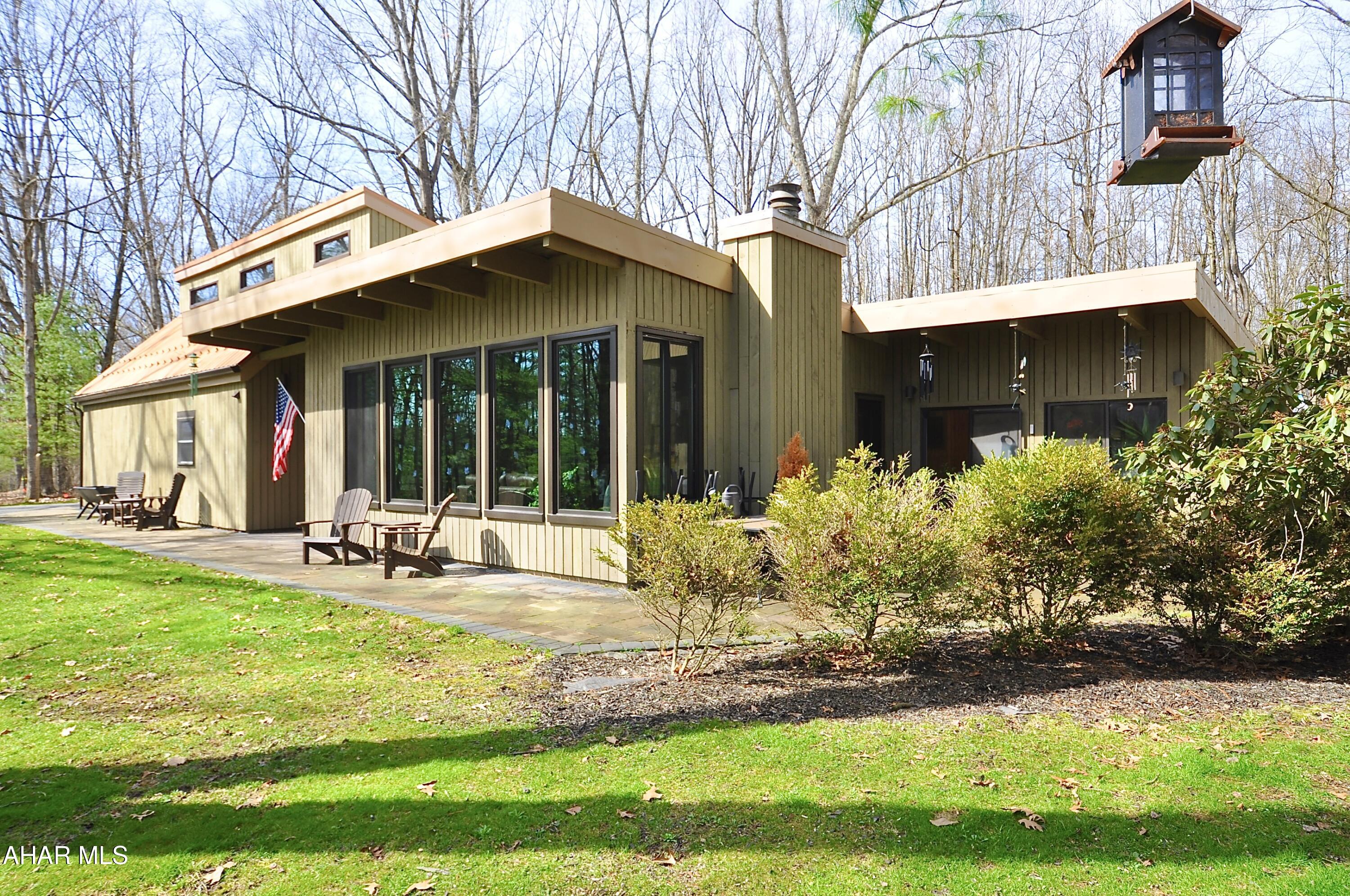 Wow! This one of a kind salt box/sprawling ranch hybrid is situate on just over 1 acre along Beaver Branch Road in Pennsylvania Furnace. Words can't really describe this incredibly beautiful home. Major upgrades include almost all new windows and skylights as well as new metal and rubber roofs and 5 new mini split heating/cooling units. Indoor heated pool! Private end of cul de sac location. Soaring trees but lots of sunlight! No one will even know you are there. See the photos and see the property in person soon. It will not last. Square footage is based on personal measurements and public records. Heated pool area included in living space as it is heated by electric baseboard as well as the pool itself. Square footage based on public records and Listing Agent measurements. Buyer Agent and Buyer to verify if desired.