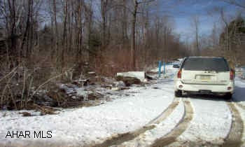 Cambria Township, Cambria County.  form Ebensburg W on 422 approx 4.5 miles to Reed Hall Road (right turn)  go approx 1.5 miles and  make a right on scout Dam Road.  Lot borders Scout Dam Road