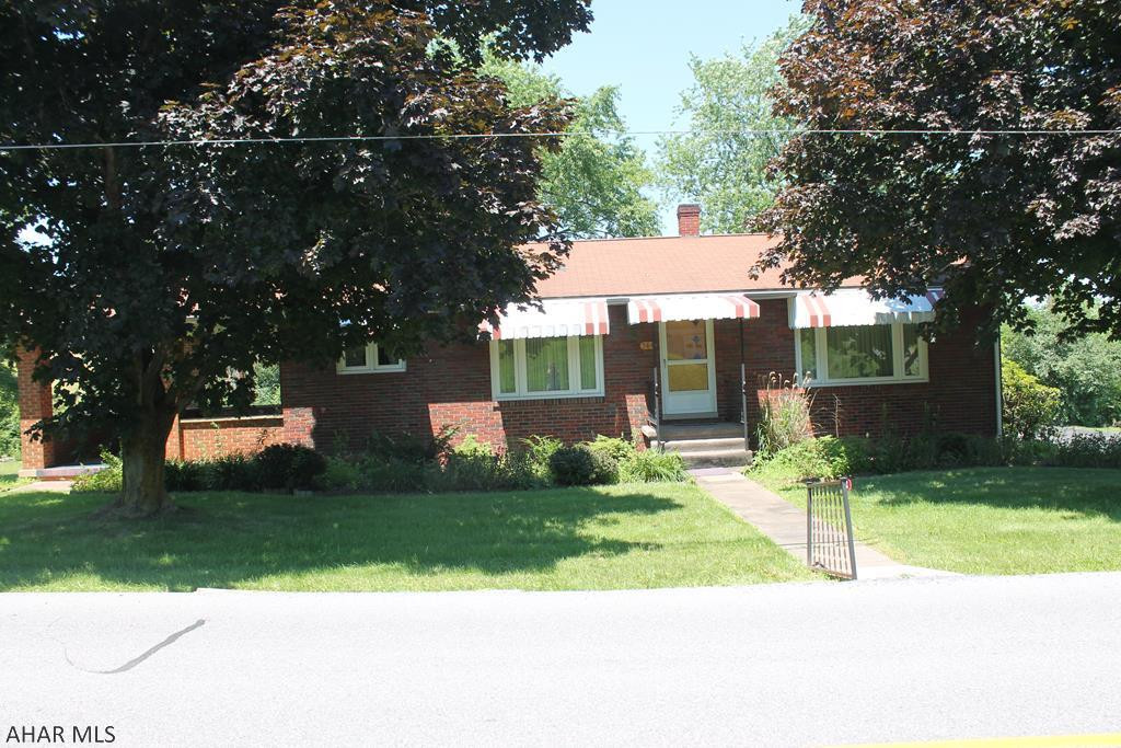 Come and take a look at this classic brick home in Hollidaysburg! beautiful Hardwood floors and trim with carpeted bedrooms. A Covered Porch surrounded in warm brick will be your favorite spot to relax on a nice day. This home also features a large backyard and a shed! Kitchen and Bathrooms need updates, but it is the perfect blank canvas for your dream home! Another parcel included..