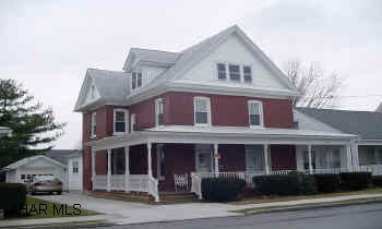 One block from park. Spacious brick colonial two story.  Two garages.  Enclosed porch.  Lovely two story brick colonial with four bedrooms, one & 1/2 baths, family room, one car garage, two car garage, first floor laundry.