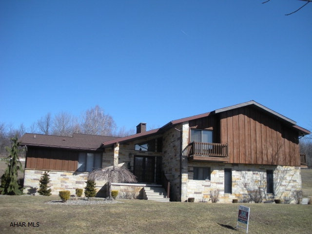 Beautiful Cedar & Stone 4 level home on private cul-de-sac. 4 bedrooms, 4.5 baths, 3 fireplaces, 2 family rooms, new oak hardwood floors, newer carpet in the family room. Balconies off 3 of the bedrooms. The kitchen is all cherry w/chocolate stain, granite counters, S/S Kitchen Aide appliances, wine service area with wine refrigerator!7 zone heat system, central vac. 2 car garage, covered patio-epoxy floor covering in garage and porches. Potential for rental income or in-law suite in lower level.