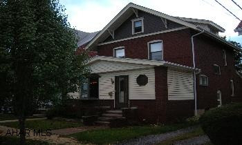 Beautiful 2 story brick with 3 bedrooms and finished attic.  This home has all natural golden oak trim, hardwood floors, enclosed front porch, new roof, updated windows, fenced yard, and 2 car detached garage.