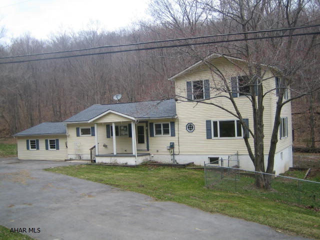 2 Story vinyl Bellwood Antis home on over 1/2 acre in need of major TLC.  . Large living room, beautiful eat-in kitchen with breakfast bar and dining area, 3 first floor bedrooms and bath, plus large 2nd floor Master Suite with full bath and walk-in closet. 2 car attached garage, large fenced yard and wild trout stream off back yard. Property sold AS-IS. Seller will make no repairs. Offers must be submitted through HUD approved broker. Buyer pays both transfer taxes. Equal Housing Opportunity.