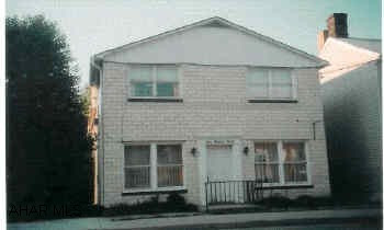 Two story, glazed block building plus 20'x40' garage building with partial second floor for storage. "Laundry Room" has hookups but no equipment. Three 2 Bedroom apartments 1st floor was occupied by owner and is the largest - 2 units ready to rent with minor updating.