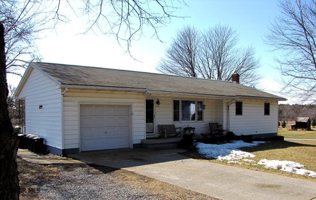 Peaceful, quiet country living! The Lot on right side (facing house) to the corner is included. Pool is included or can be taken down. All appliances in the eat-in kitchen are included. This home has lots of natural light. Could be converted to handicap accessibility with little modifications. One car garage, front porch, cement driveway, back patio.  All new windows. A must see!!