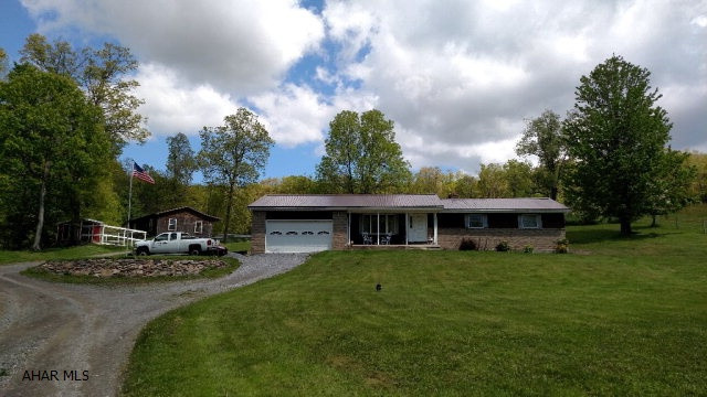 Rare opportunity in Antis Township!  If you are looking for complete privacy, this is it!!  4 bedroom, 2.5 bath ranch home with spacious rooms.  Oversized, eat-in kitchen with stainless steel appliances included!  Lower level is finished with a family room that offers and abundance of space, brick/wood fireplace and 1/2 bath.  Private covered back deck and 3 car garage.  11.5+ acres that is partially wooded, but also offers open pasture set up for horses!  6 stall horse barn with finished tack room, electric and water, storage loft.  Additional 30x22 garage with electric and heat.  Due to the private location the seller is asking for no drive bys and qualified buyers only.  There is a recorded road maintenance agreement in place.