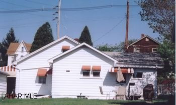 One-story frame house on corner lot featuring 2 bedrooms, a family room, and central A/C.