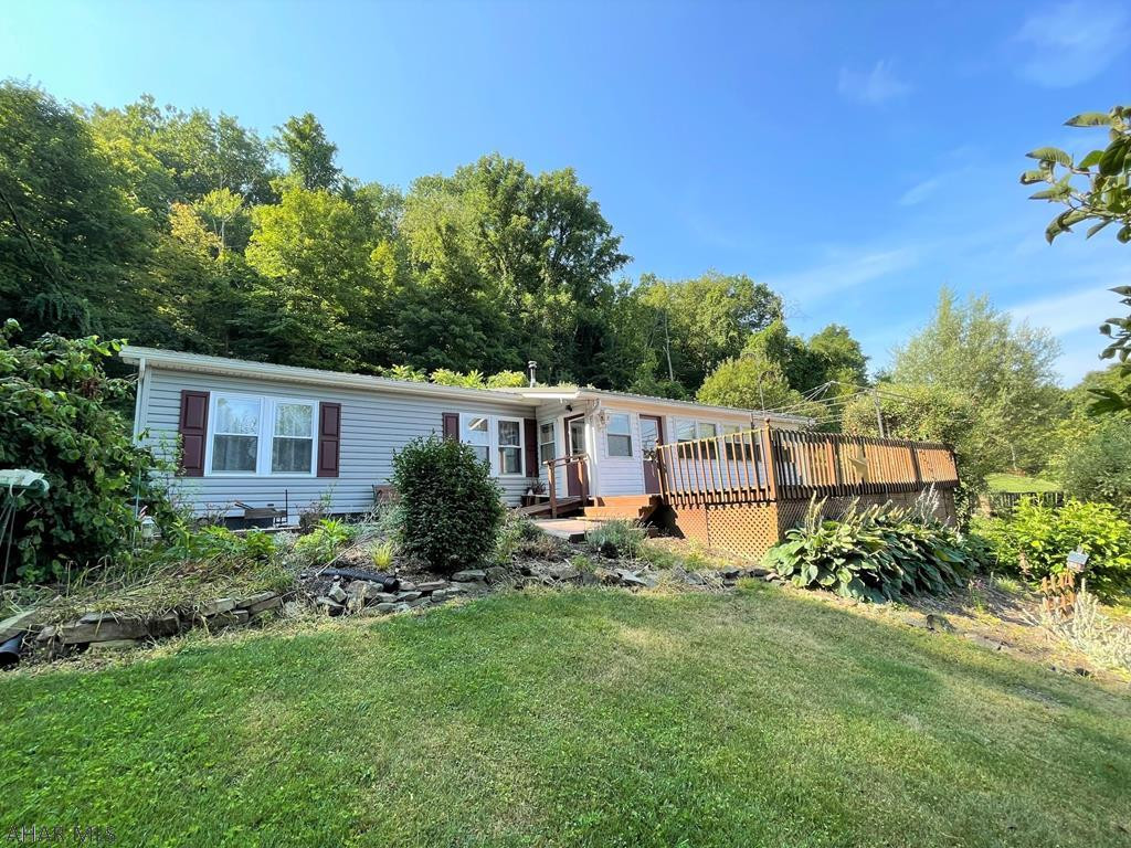 Very well maintained & nicely updated double-wide home resting on 8-acres!! This home offers a LR, kit w/ oak cabinetry, DR, master bedroom w/ en-suit bath, two additional bedrooms & another full bath. Large enclosed porch perfect for entertaining & front deck for relaxation. Two-car detached garage w/ workshop area & two sizable storage sheds. Electric forced air heat w/ central air-conditioning, private well & private septic system. Metal roof, vinyl siding, & insulated replacement windows. Property ADJOINS State Game Lands #97 containing 7,612 acres!! Approximately 11 miles of the Mid-State Trail are located on SGL #97. This property has been well cared for, offers nice updates, & is move in ready! Super convenient location between Bedford & Everett w/ easy access to major roads.