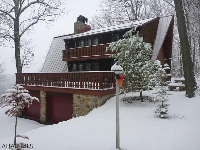 The meticulously maintained Town & Country Western Red Cedar chalet with a setting that will captivate. 14.78 Wooded acre lot w/panoramic views + 1 acre that includes ab active vineyard and small garden. The 2916 sq. ft. interior has 4 bedrooms, 3 1/2 baths, living room, dining room, kitchen w/granite counter tops and copper backsplash. The exterior of the home has six decks to take in absolutely stunning views of the Allegheny Mountainside while the above ground pool feels more like an infinite pool because it was designed around the slope of the property. A 28 x 36 post and beam 2 story storage barn, a small wood shed, a tree house, spa room w/hot tub and sauna.