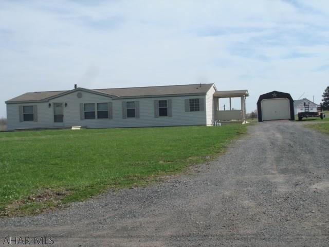 Like new 3 bedroom, 2 bathroom doublewide on a full (poured) foundation with walkout (stairs). The living room, dining room and kitchen (eat-in) have a nice open floor plan.  A very spacious master suite with walk-in closet, garden tub, walk-in shower and double bowl sink.  Another full bathroom and 2 bedrooms complete the main level. The full unfinished basement with poured walls is very large and could be finished for additional living space.  A large open front porch, a cement patio at the back, and a covered porch at the side allow for lots of outside enjoyment.  A one car detached garage and 1.5 acres makes this an exceptionally nice property.  A quiet country setting and beautiful views are sure to please. Utilities are all underground.  The property has central air conditioning.