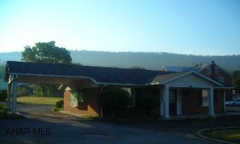 Brick structure formerly used as a bank(current restriction - cannot be used as a bank), two half baths, small kitchen.  Bring your business to this convenient location!! .23 acres, #D9C7-85. One restriction - no lending/banking facility allowed.