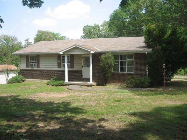 Country living on almost an acre; the home has lots of possibilities! Three bedrooms and 2 full baths. Kitchen has nice cabinets; stone fireplace in the LR; sliding doors from the dining area to the back patio.  The property is mostly lined with trees.  It's along a public road with good access but still semi-private; no visible neighbors.  A garage for storing lawn tractor, etc.  Paved driveway to side entrance. Garden area. Full basement unfinished. The home is in good shape but needs updated - mostly flooring and LR window. 10 minutes from Huntingdon. A great opportunity to live in the country at a good price.