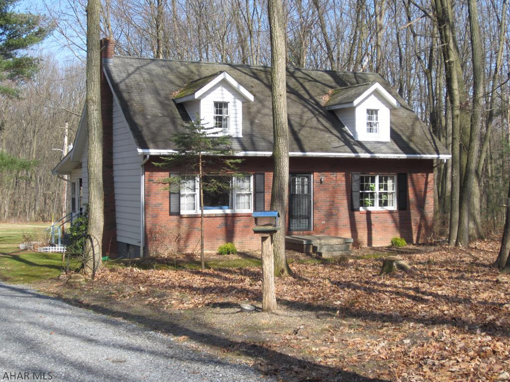 Acreage, Acreage, Acreage!!!  If you want some "elbow room" and a peaceful setting, here is your opportunity.  With ten plus acres this property is nicely positioned in the Smith Development.. It is 85 - 90% wooded and has wild rhododendrons on it.  The nestled in 1 1/2 story cape cod style house has three bedrooms, two are upstairs and a master bedroom along with laundry on main floor.  Fulls baths are on each floor and a potential third bath has roughed in plumbing in basement floor.  House has lots of storage.  Hot water heat, 200 AMP electric box and front of house is bricked case.  Closed in back porch.  Owner will not be moving from the property until 6/20/22.