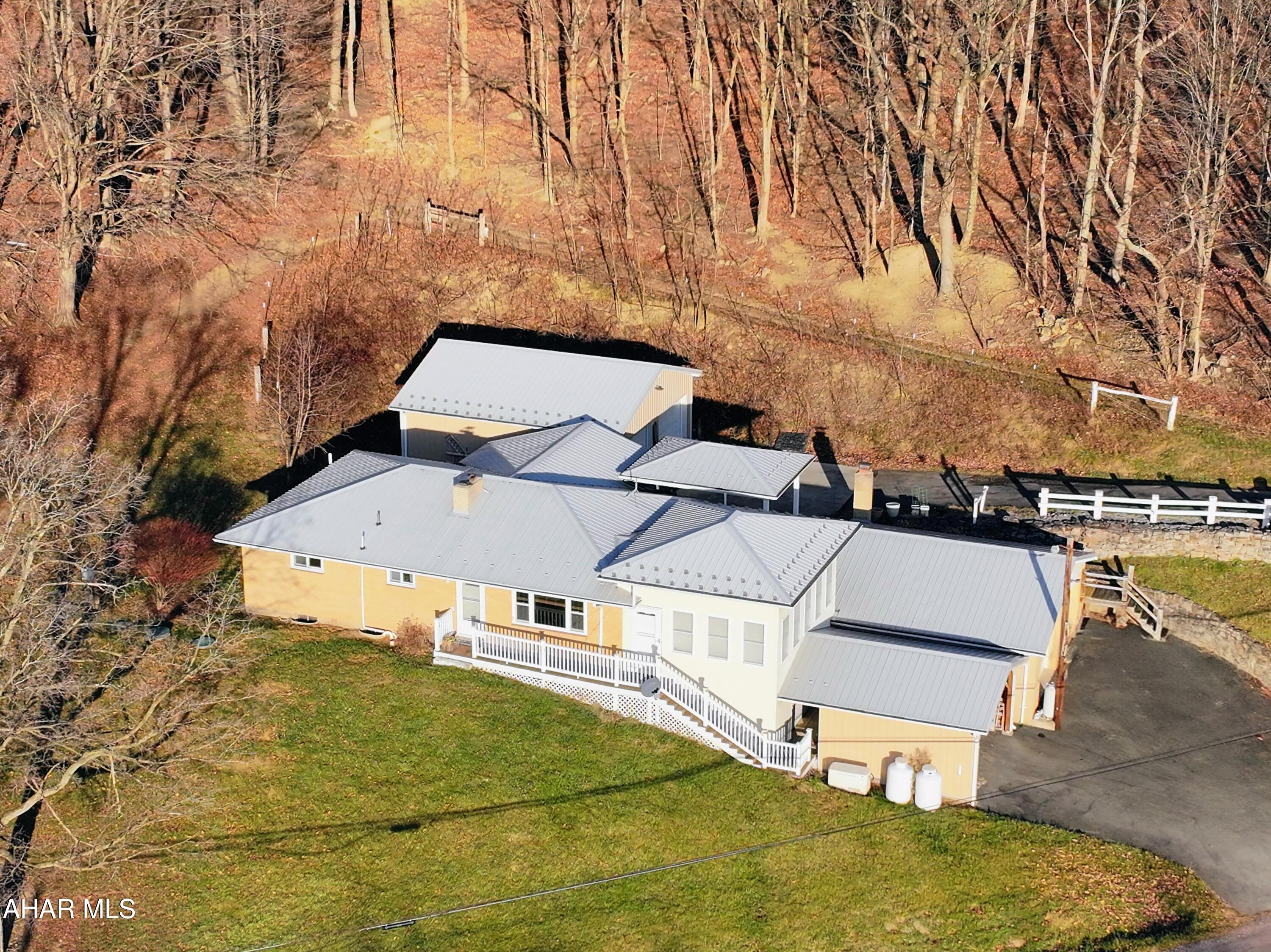 Spacious brick ranch on 2.5 Acres with endless storage, workshops and upgrades.
So much house for your money! This sprawling brick ranch sits on 2.5 acres in the Meyersdale Area School District, offering privacy, space, and an impressive list of features. Ideally located within minutes of Wellersburg, Pleasant Union, Hyndman, and Cumberland, MD, you're never far from amenities while still enjoying peaceful country living.

Inside, you'll find a large carpeted office with a sliding glass door that opens into the eat-in kitchen, which flows into the cozy living room complete with a built-in bookcase. The highlight of the home is the sun-filled all-season room, equipped with its own mini-split and outside access--perfect for watching stunning sunsets year-round.

The main floor offers 3 bedrooms and 1 full bath featuring a walk-in shower. Comfort is key with central air, electric baseboard heat, ceiling fans throughout, and multiple heating options: a large Harman wood/coal boiler with gravity-fed heat, heat pump, or electric.

The spacious basement provides incredible potential, including an area with a brick fireplace and full bath. Recent updates include a 40-gallon hot water tank (2022), sump pump, radon mitigation system (2021), 200-amp electrical service, and a brand-new irrigation drip septic system.

Car storage and workshops are a dream here. You'll find:
A carport and one-car integral garage at the basement level along with a cold storage/canning cellar that leads to another attached two-car garage with openers.
A massive 30' x 30' main-level workshop, a craftsman's paradise, with its own 200-amp service, mini split for cooling, two insulated 10' garage doors, and optional dust collector.

Additional peace of mind comes with the Generac propane generator, already hooked up for seamless use during power outages.

This is a home that truly needs to be seen to appreciate all it offers--space, flexibility, and thoughtful upgrades throughout.