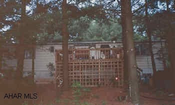 Doublewide on foundation with full foundation. 3BR, 2.5 baths. well and pump put in 3 years ago. Road frontage on 96 +/- acres. Timbered 20 years ago.